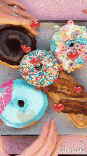 a bunch of donuts with hearts on them and the hashtag #photolab