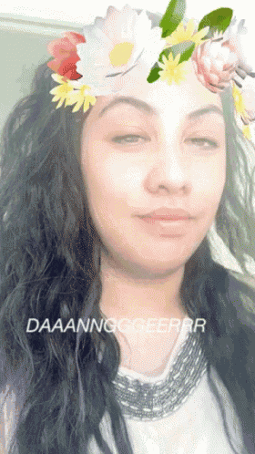 a woman with a flower crown on her head says daaanngggeerr on the bottom