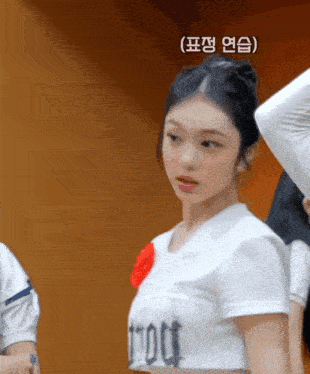 a woman wearing a white shirt that says tmoot on it