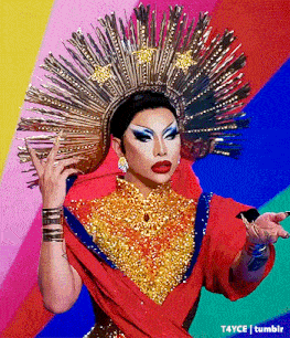 a drag queen is wearing a crown and a red and gold dress