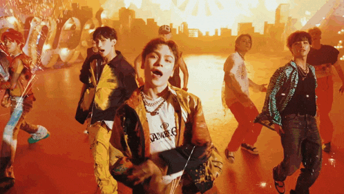 a group of young men are dancing and one of them is wearing a t-shirt that says ambush