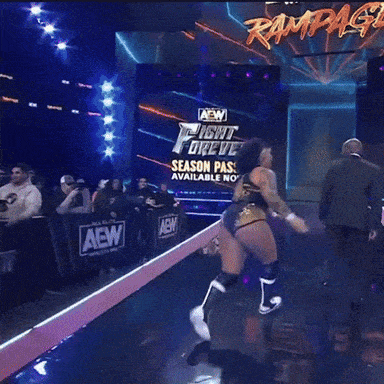 a wrestler on a stage with a sign that says rampage on it