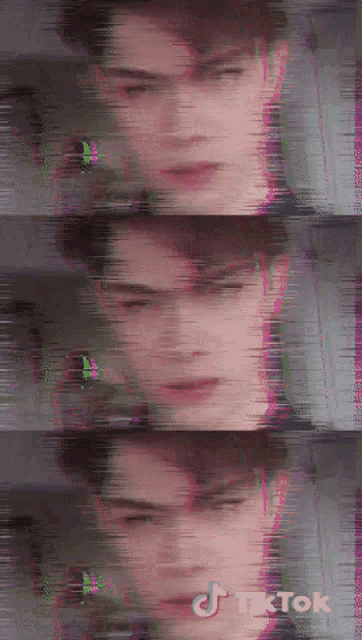 a blurry picture of a man 's face with a tiktok logo on the bottom right