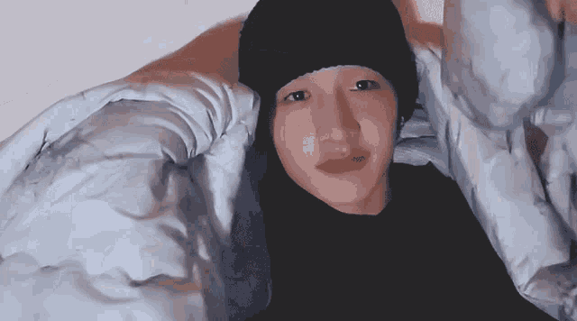 a person wearing a black hat and a black shirt