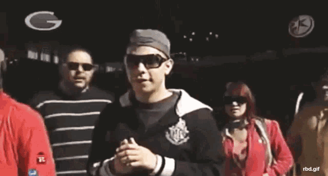 a man wearing sunglasses giving a peace sign