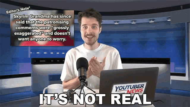 a man sitting in front of a laptop that says youtube news