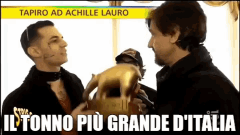 two men are standing next to each other with the words il tonno più grande d' italia on the bottom