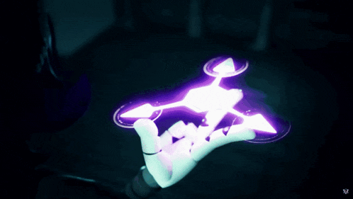 a purple and white circle in the dark with the letter v on the bottom right