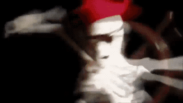 a close up of a person 's face with a red hat on