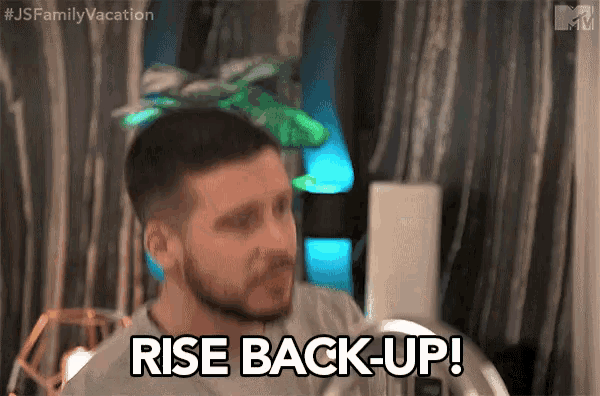a man with a beard is saying rise back-up