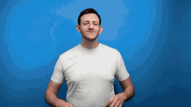 a man in a white shirt is making a funny face