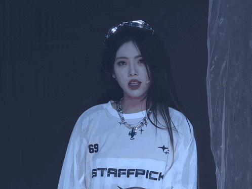 a woman wearing a white shirt that says affrick on it