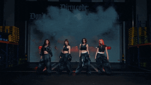 a group of women standing in front of a dirty work logo