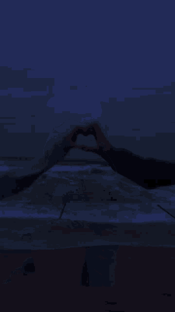 a man and a woman are hugging in the dark .