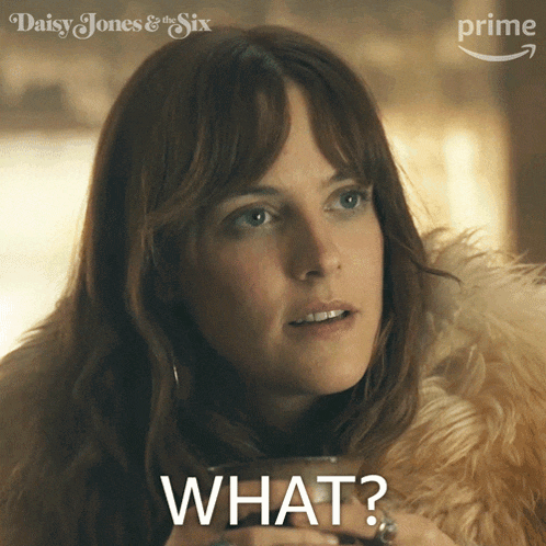 a woman in a fur coat is holding a cup of coffee and says " what "