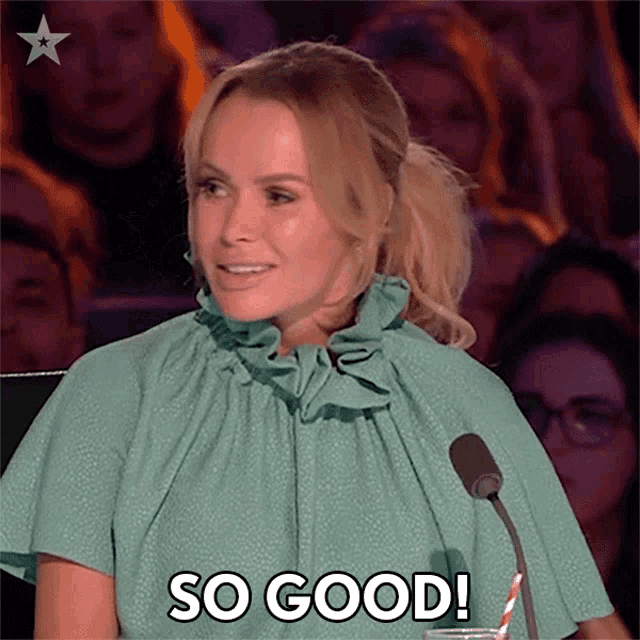 a woman in a green dress is sitting in front of a microphone and says so good .