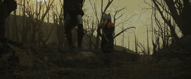 a couple of people in a dark forest with a light coming out of their hands