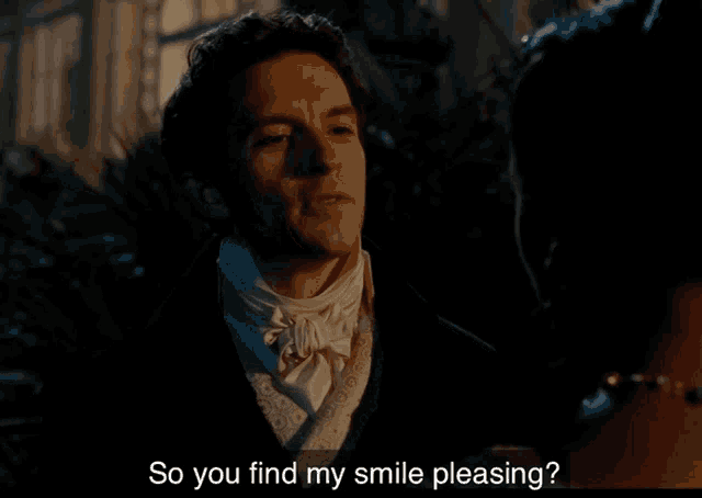 a man in a tuxedo talks to a woman and the words so you find my smile pleasing