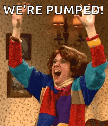 a woman in a colorful sweater is raising her arms in the air with the words we 're pumped written above her