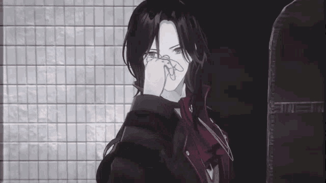 a person covering their face with their hand
