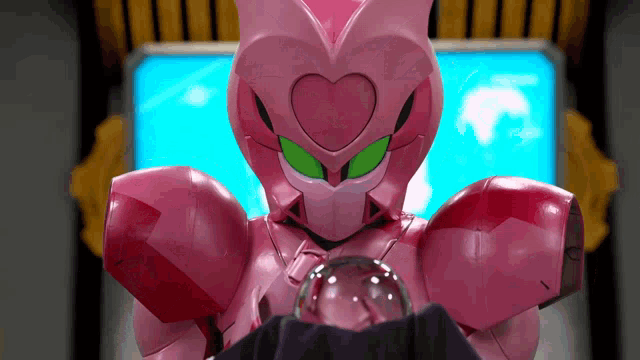a pink robot with a heart shaped face and green eyes