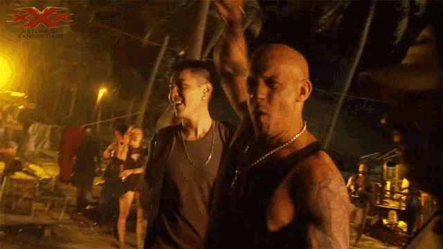 a man with a tattoo on his arm is standing in front of a sign that says x-men