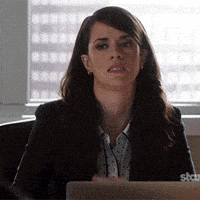 a woman sitting at a desk with a laptop that says star on the bottom