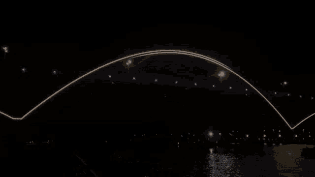 a bridge that is lit up at night with a few lights on it