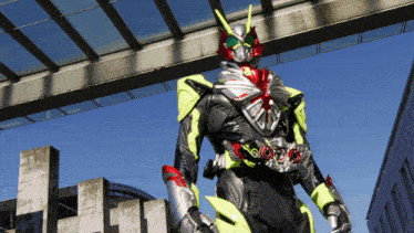 a man in a black and yellow costume is standing in front of a bridge