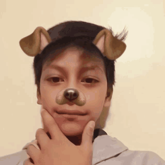 a young boy wearing a dog mask on his face with his hand on his chin