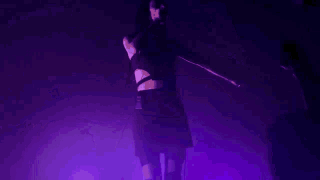 purple lights are shining on a dark background