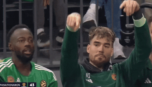 two basketball players wearing green jerseys with the number 43 on them