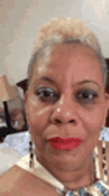 a close up of a woman 's face with red lipstick .