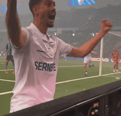 a man wearing a white shirt that says sernee