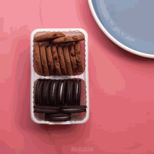 a plastic container filled with chocolate chip cookies and oreo cookies