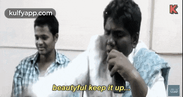 a man is singing into a microphone with the words `` beautiful keep it up '' .
