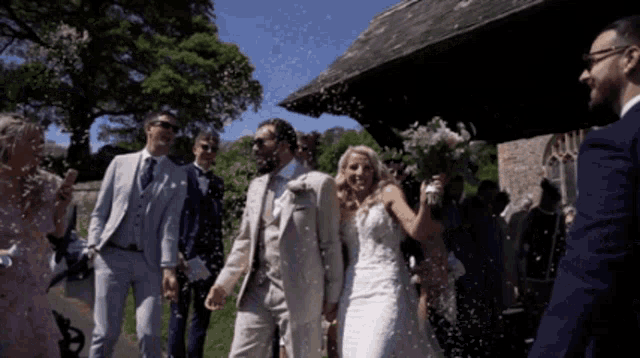 a bride and groom are being showered with confetti by their wedding guests