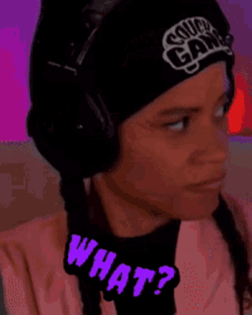 a woman wearing headphones and a beanie that says couch gang on it