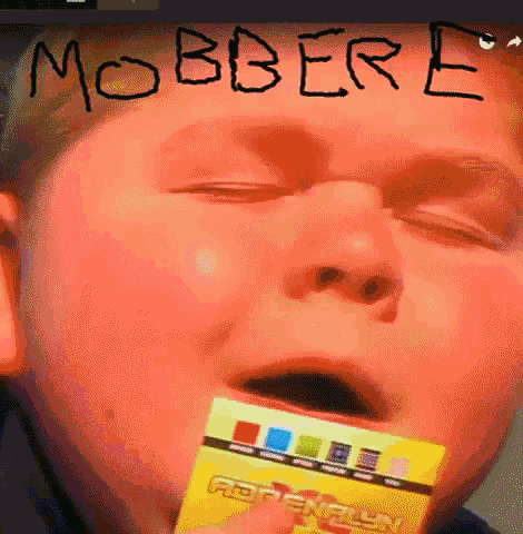 a boy holding a card with the word mobbere written on it