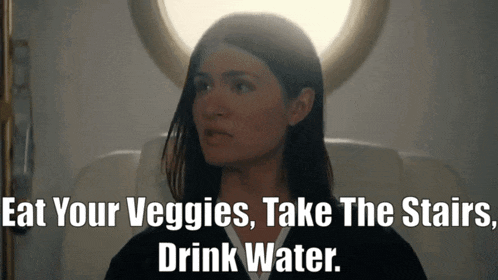 a woman sitting on an airplane with the words " eat your veggies take the stairs drink water " above her