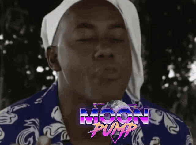 a man wearing a bandana and a blue shirt with the word moon pump on the bottom