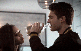 a man is pouring a drink into a woman 's glass