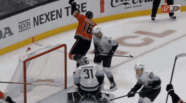 a hockey game is being played in front of a banner for nexen tire