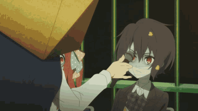 a girl with a mask on her face is being touched by a person