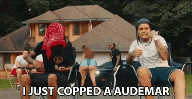 a group of people are sitting in chairs in front of a house and one of them is wearing a bandana .