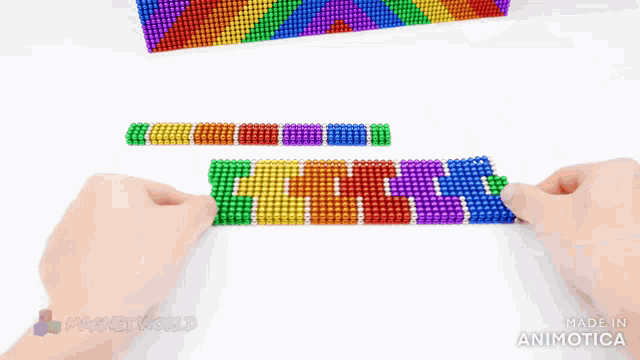 a bunch of colorful beads with the word magnetworld on the bottom right