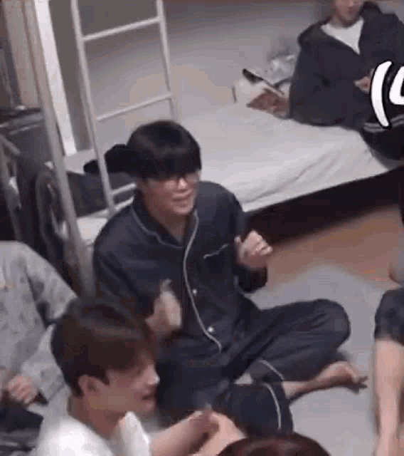 a group of people are sitting on the floor in a living room .