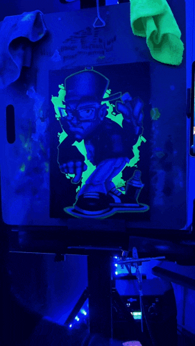 a glow in the dark drawing of a man wearing a hat and glasses