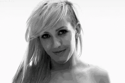 a black and white photo of a naked woman with a shaved side .