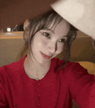 a woman in a red shirt takes a selfie